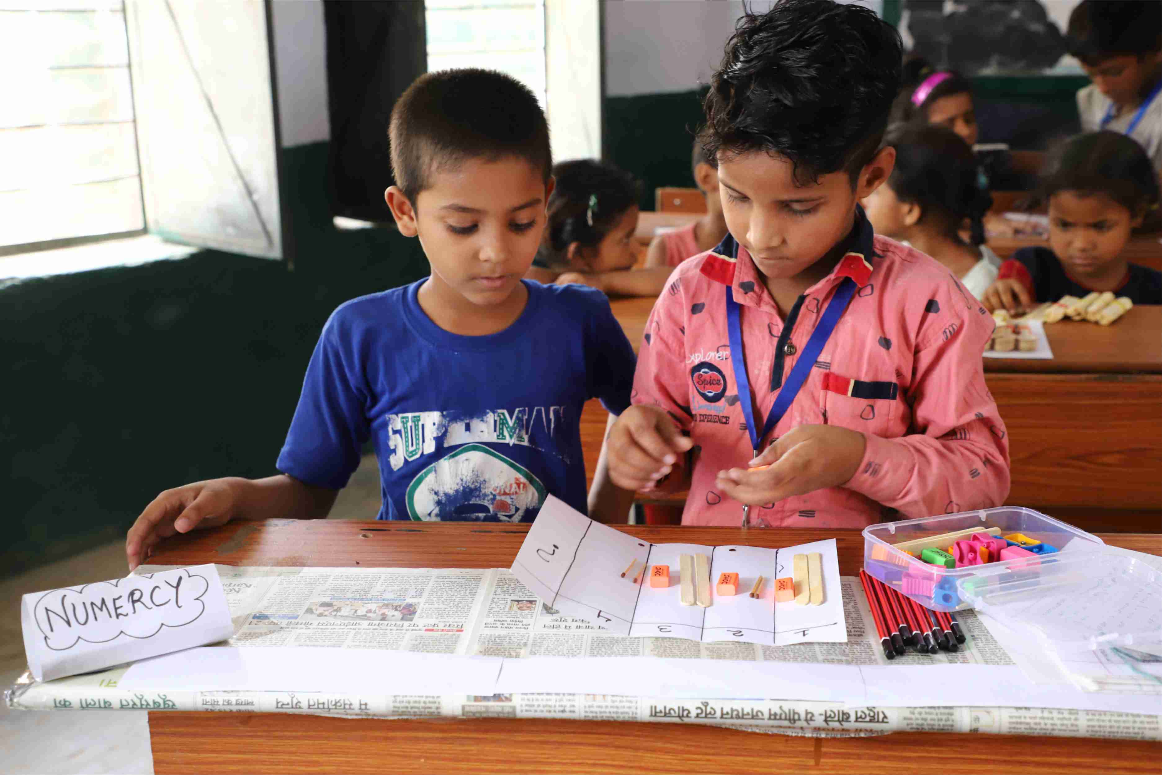 Children reading together with ALfA learning materials in a classroom